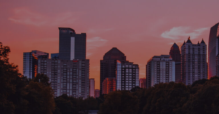 tall buildings in town at sunset